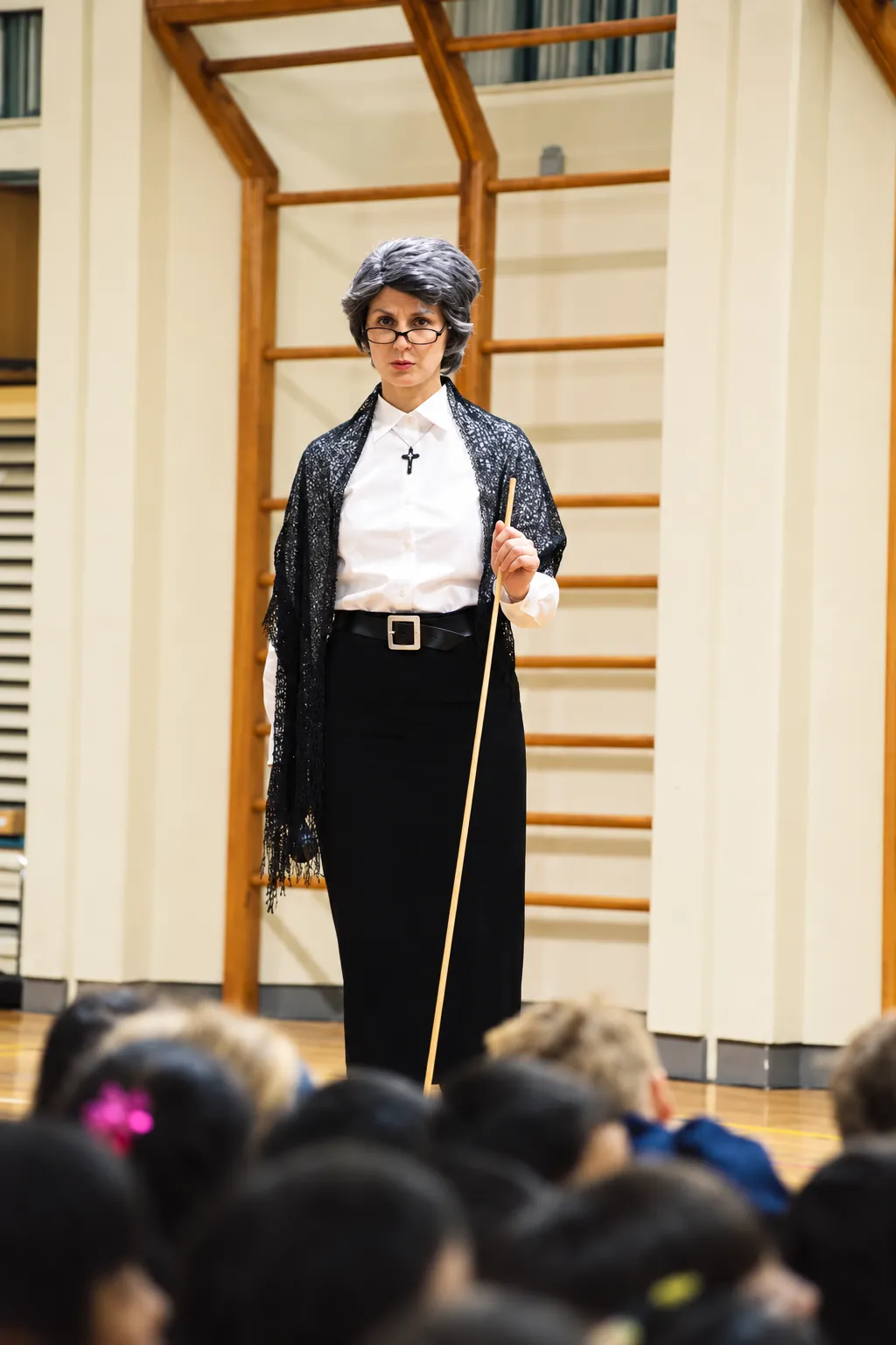 Donna in Victorian-era costume addressing students
