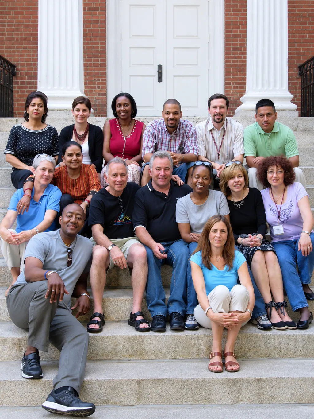 A group of educators seated on steps
