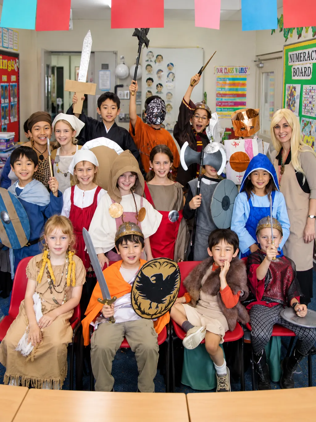 Donna with students dressed in Viking costumes in a classroom